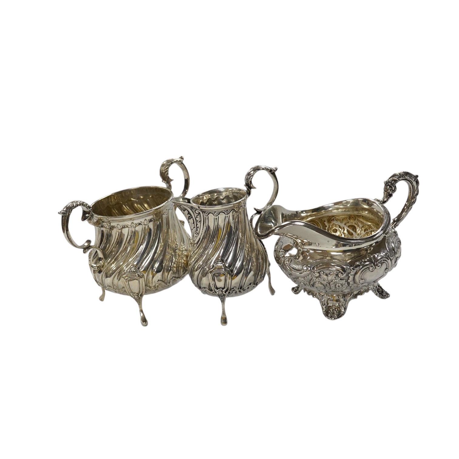 A late Victorian silver cream jug and sugar bowl, by Mappin & Webb, London, 1900 and an earlier William IV silver cream jug, London, 1835, 16.1oz. Condition - fair to good